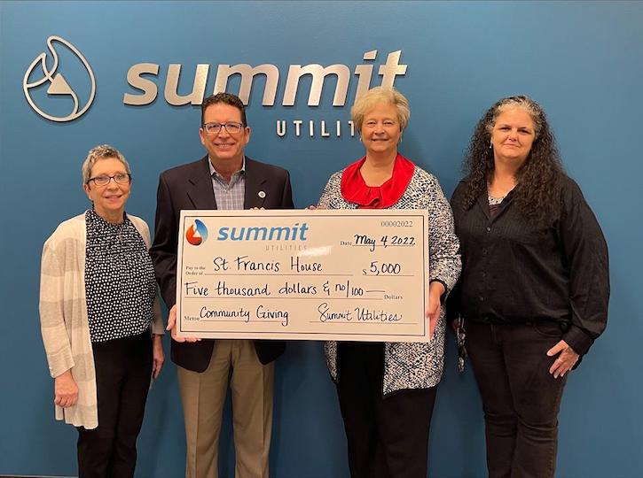 Summit team members presenting $5,000 check