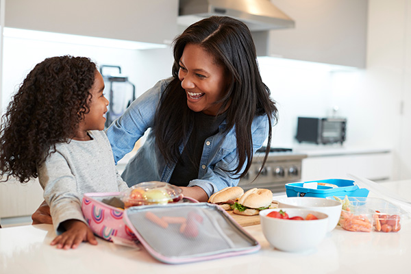 Mom & daughter in kitchen with gas stove