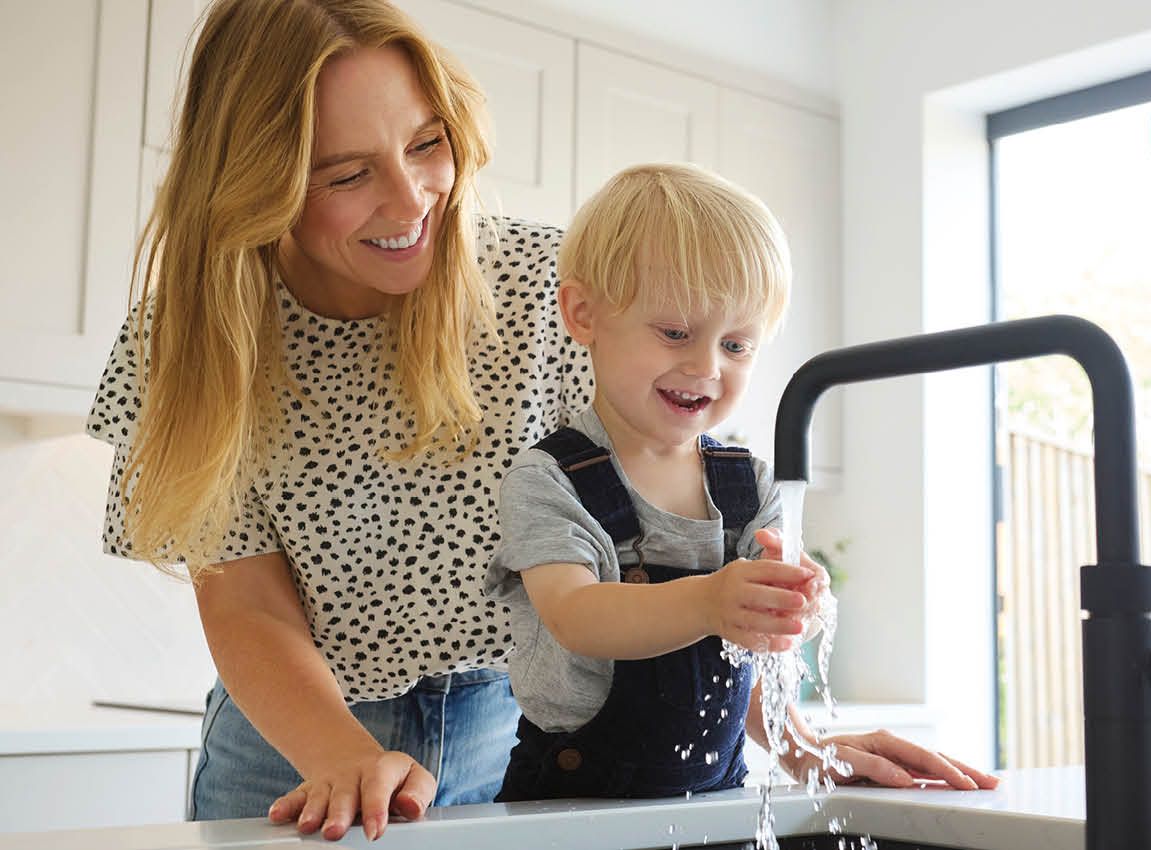 Mom and son washing hands with warm water