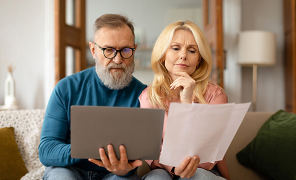 Couple paying bills on a laptop