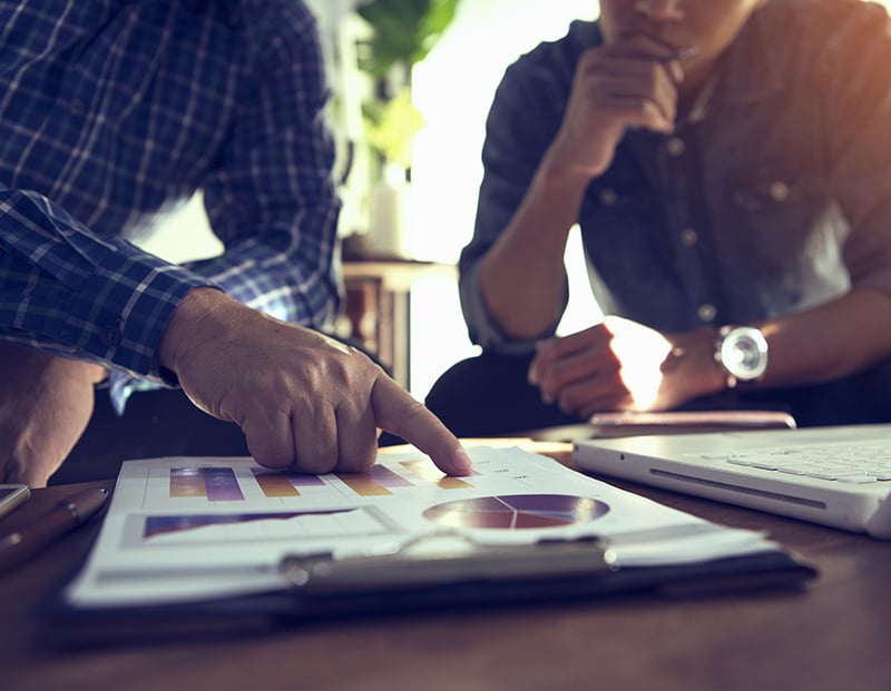 two people discussing paperwork