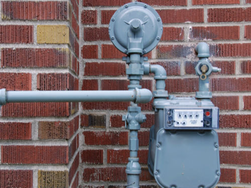 gas meter on the side of a brick home