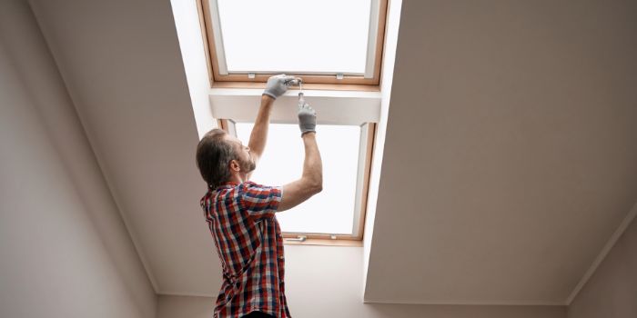 man checking window sealing