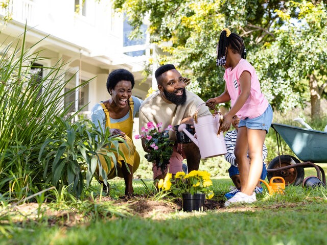 Family planting flowers