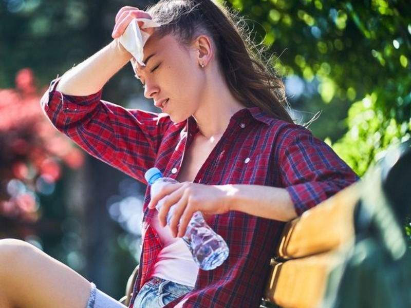 girl showing signs of heat exhaustion