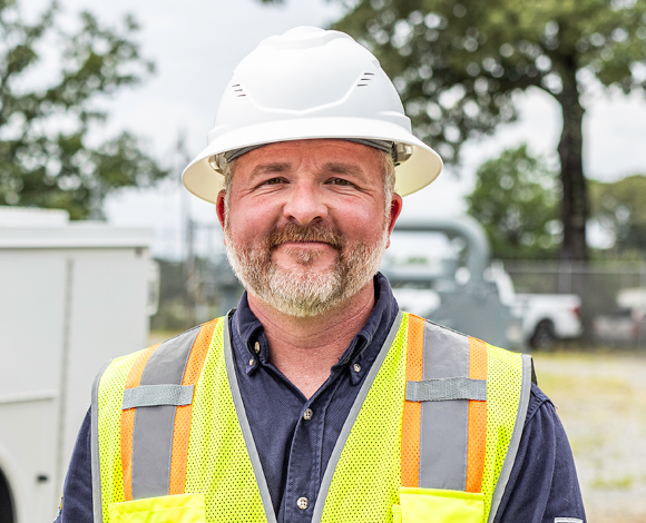 Summit team member standing in front of truck